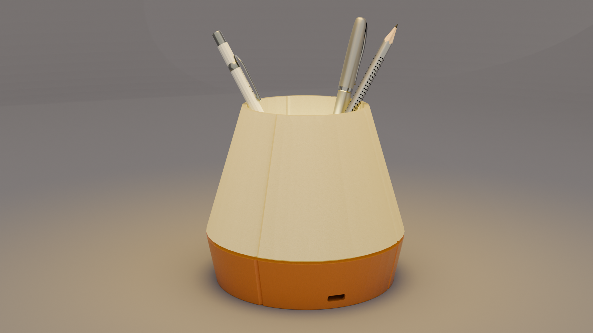 The Litele Duo Orange lamp, lit and functioning as a pen holder, with pens inserted